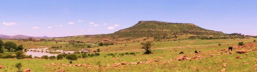 View of Shiyane Mountain: Isandlwana on the skyline above the Buffalo River and Rorke's Drift Mission Station in the trees at the right
